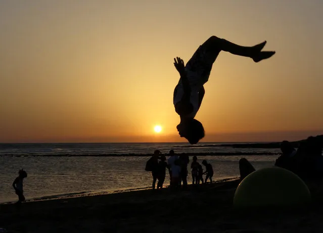 A youngster flips in the air as the sun sets at Zahora beach in southern Spain, July 16, 2016. (Photo by Paul Hanna/Reuters)