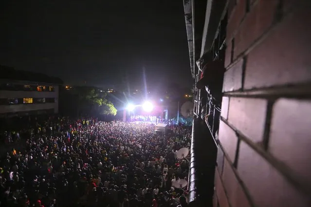 Thousands of people attend a music concert to celebrate the new year in Mbare, Harare, Friday, January 1, 2021. Despite a government ban on music concerts and public gatherings due to a surge in COVID-19 infections and the new and more contagious variants of the disease, thousands of people gathered in one of the country's poorest neighborhoods to celebrate the new year. (Photo by Tsvangirayi Mukwazhi/AP Photo)