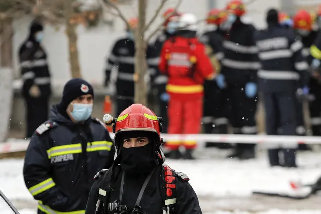 Firefighters walk at the the Matei Bals hospital compound after a fire broke out in one of its buildings in Bucharest, Romania, Friday, January 29, 2021. A fire early Friday at a key hospital in Bucharest that also treats COVID-19 patients killed four people, authorities said. (Photo by Vadim Ghirda/AP Photo)