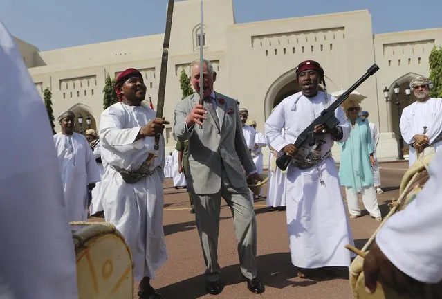 Britain's Prince Charles dances with a sword with a group of Omani traditional dancers in Muscat, Oman, Saturday, November 5, 2016. Prince Charles and his wife Camilla have started a three-nation royal tour of the Gulf in Oman.  Prince Charles landed in Muscat on Friday night, greeted at the airport by Omani Heritage and Culture Minister Sayyid Haitham Bin Tariq Al Said.  (Photo by Kamran Jebreili/AP Photo)