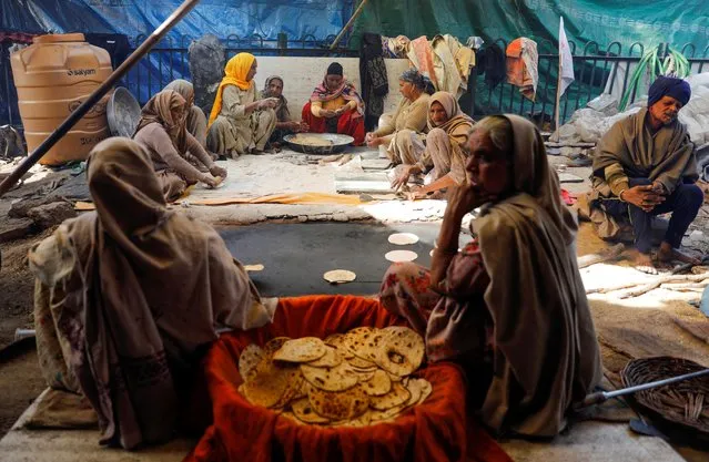 Women prepare meals at a site of a protest against the farm laws in New Delhi, India, January 30, 2021. (Photo by Adnan Abidi/Reuters)