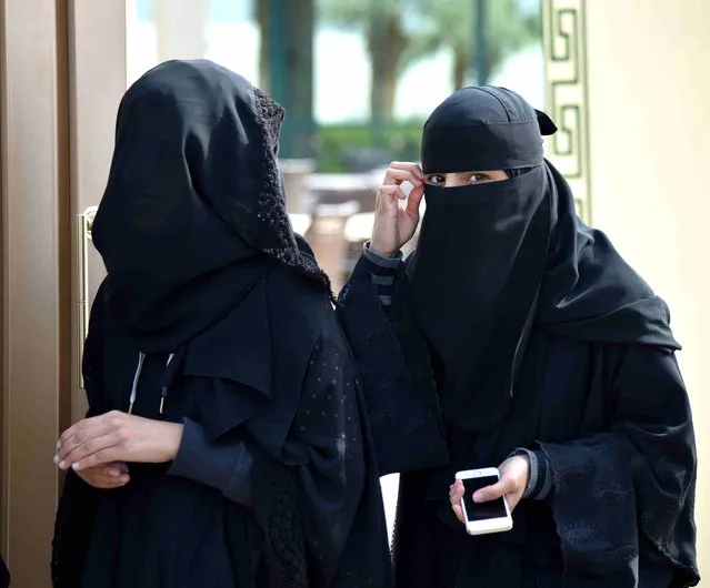 Saudi Arabia's first elections open to women. Burka wearing women walk out of a polling station after casting their votes for municipal elections in Riyadh, December 12, 2015. More than 1.4 million people are eligible to vote, including 130,637 females who will be allowed to contest and cast ballots in the third municipal poll. (Photo by Wang Bo/Xinhua via ZUMA Wire)