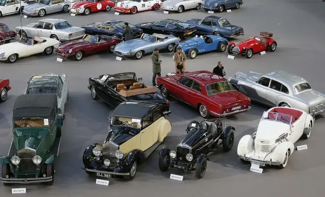 Visitors look at vintage and classic cars displayed ahead of the Bonhams' Les Grandes Marques du Monde vintage motor cars and motorcycles auction at the Grand Palais exhibition hall as part of the Retromobile vintage car show in Paris February 4, 2015. (Photo by Gonzalo Fuentes/Reuters)