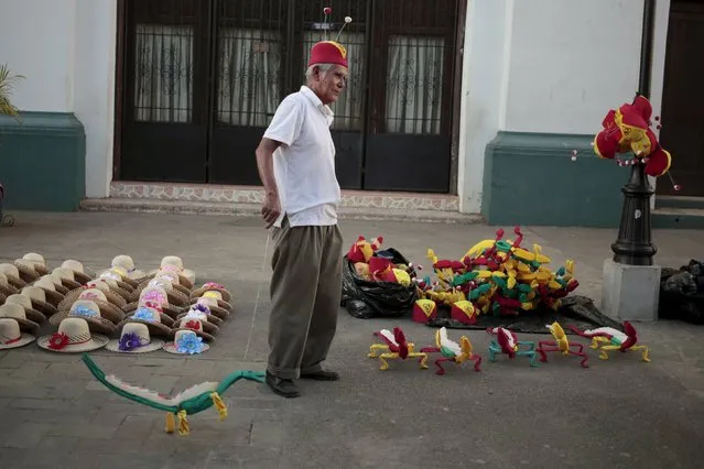 A man sells Chapulin Colorado hats at Leon, Nicaragua December 7, 2015. Chapulin Colorado, also known as The Red Grasshopper, is a character from Mexican television series "El Chapulin Colorado". (Photo by Oswaldo Rivas/Reuters)