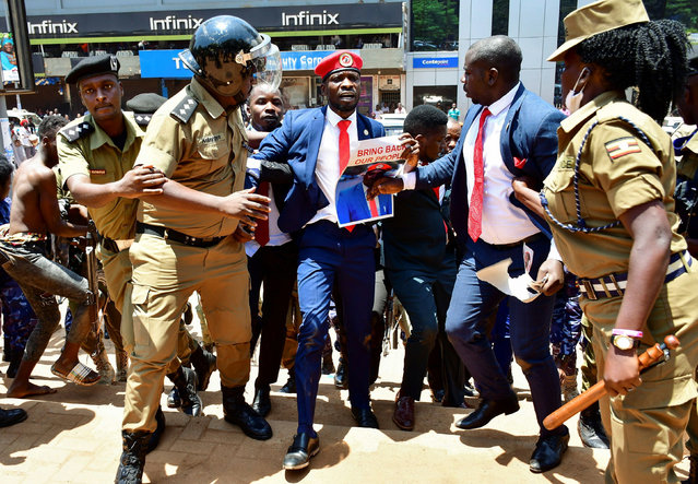 Ugandan opposition leader and singer Robert Kyagulanyi Ssentamu (C), known as Bobi Wine, is detained by riot-policemen during an anti-government demonstration in Kampala, Uganda on March 15, 2021. (Photo by Abubaker Lubowa/Reuters)