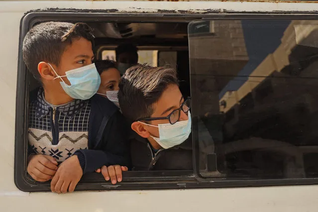 Palestinian students wait inside a school bus to go home in Gaza City on March 3, 2021. (Photo by Mohammed Abed/AFP Photo)