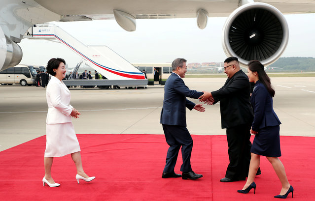 South Korean President Moon Jae-in is greeted by North Korean leader Kim Jong Un during an official welcome ceremony at Pyongyang Sunan International Airport, in Pyongyang, North Korea, September 18, 2018. (Photo by Pyeongyang Press Corps/Pool via Reuters)