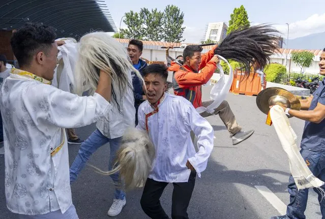 Family and friends dance as they welcome Norwegian woman mountain climber Kristin Harila, and her Nepali Sherpa guide Tenjen Sherpa, who on Thursday set a new record by scaling the world's 14 highest peaks in 92 days at the airport in Kathmandu, Nepal, Saturday, August 5, 2023. (Photo by Niranjan Shreshta/AP Photo)