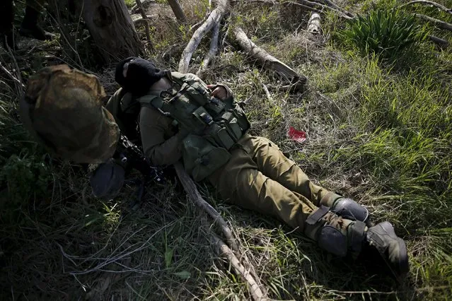 An Israeli soldier rests during military activity across from the Israeli-Gaza border in southern Israel January 13, 2016. (Photo by Amir Cohen/Reuters)