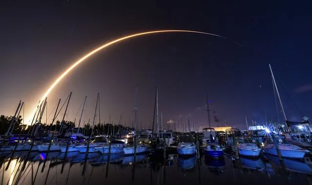A SpaceX Falcon 9 rocket takes off from Launch Complex 40 at Cape Canaveral Space Force Station as viewed from Harbortown Marina on Merritt Island, Fla., late Saturday, August 26, 2023. The rocket is on an internal mission to launch 22 Starlink satellites. (Photo by Malcolm Denemark/Florida Today via AP Photo)