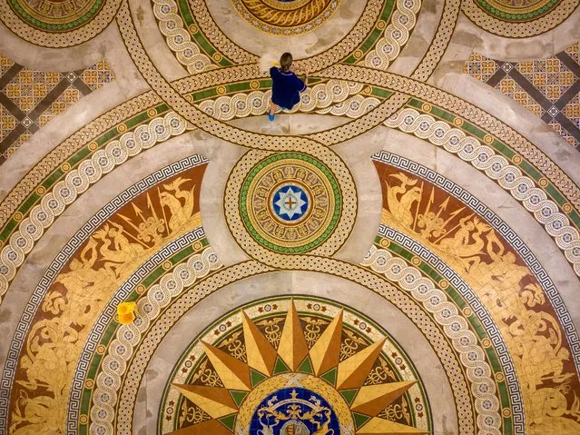 In this aerial image from a drone a council cleaner poses for the media as she cleans a section of the rarely seen Minton tiled floor of the grand St George's Hall on July 31, 2023 in Liverpool, England. St George's Hall's spectacular Minton tiled Victorian floor features images of Neptune, dolphins and tritons as a nod to Liverpool's sea power. Covered in the 1860s to provide a hard-wearing surface for dancing, it is the first time the mosaic has been unveiled since 2019, and only the tenth time since the Hall reopened in 2007. The tiled floor will be on display to the public from Tuesday 1 to Friday 18 August. (Photo by Christopher Furlong/Getty Images)
