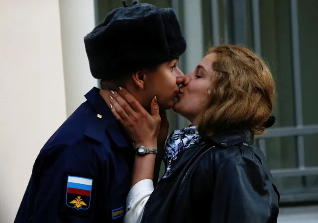 A couple shares a kiss as Russian conscripts depart from a recruiting station in St. Petersburg, Russia October 17, 2018. (Photo by Anton Vaganov/Reuters)