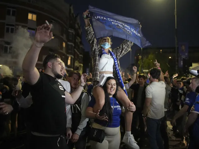 Chelsea supporters celebrate in west London, England after their team won the Champions League final soccer match between Manchester City and Chelsea which is being played at the Dragao stadium in Porto, Portugal, Saturday, May 29, 2021. Chelsea won the match 1-0. (Photo by Matt Dunham/AP Photo)