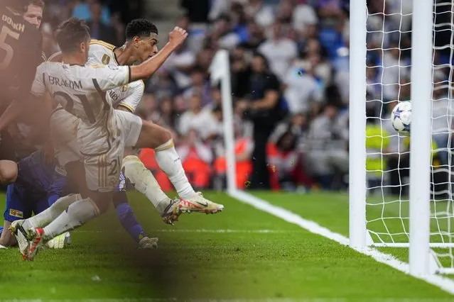 Real Madrid's Jude Bellingham scores his side's first goal during the Champions League group C soccer match between Real Madrid and FC Union Berlin at the Santiago Bernabeu stadium in Madrid, Wednesday, September 20, 2023. (Photo by Manu Fernandez/AP Photo)