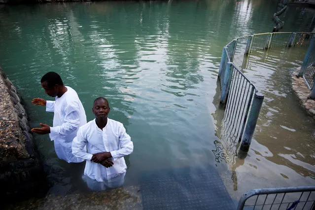 Christian tourists from Nigeria take part in a ceremony at the Yardenit baptismal site, in the Jordan River, which flows out from the Sea of Galilee, northern Israel November 30, 2016. (Photo by Ronen Zvulun/Reuters)