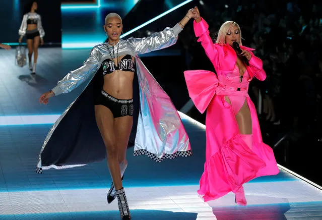 Singer Bebe Rexha (R) sings as model Iesha Hodges presents a creation during the 2018 Victoria's Secret Fashion Show in New York City, New York, U.S., November 8, 2018. (Photo by Mike Segar/Reuters)