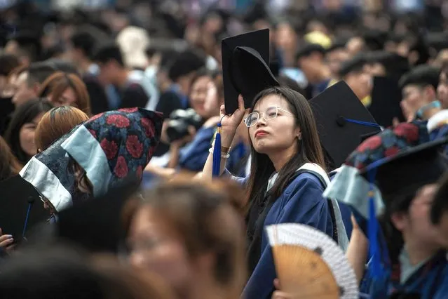 This photo taken on June 13, 2021 shows nearly 9000 graduates, including more than 2000 students who could not attand the graduation ceremony last year due to the Covid-19 coronavirus outbreak, attanding a graduation ceremony at Central China Normal University in Wuhan, in China's central Hubei province. (Photo by AFP Photo/China Stringer Network)