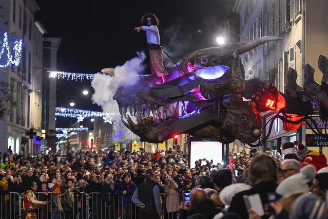 A member of the Compagnie Planete Vapeur standing on a giant animal skull performs during the parade of the festivities of Saint Nicholas in Nancy, eastern France on December 1, 2018. Lorraine started this weekend Saint-Nicolas' festivities, celebrating for 45 days the protector of the wise children, and the hope to obtain the inscription to the cultural and intangible heritage of UNESCO of this tradition rooted in the East and the North of France. (Photo by Jean-Christophe Verhaegen/AFP Photo)