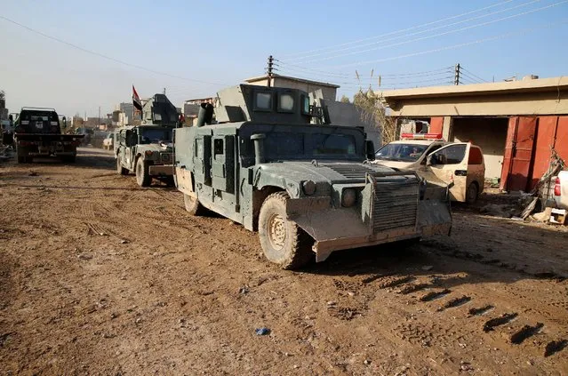 Iraqi security forces ride on military vehicles during clashes with Islamic State militants, north of Mosul, Iraq, December 30, 2016. (Photo by Ammar Awad/Reuters)