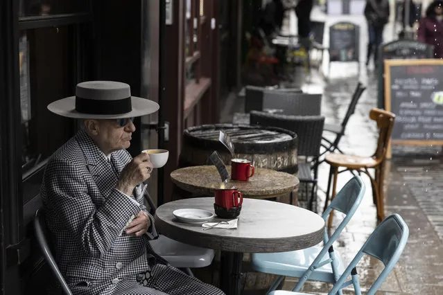 A man drinks a coffee at a cafe in Soho on May 17, 2021 in London, United Kingdom. From today, covid restrictions on indoor activities and household mixing ease across most of the UK, with indoor food and entertainment venues allowed to reopen across England and Wales, and small in-home meetings permitted once again in England and Scotland. Hugging is also once again allowed between close family and friends across the UK, except in Northern Ireland, where they remain in place until at least May 24. (Photo by Dan Kitwood/Getty Images)