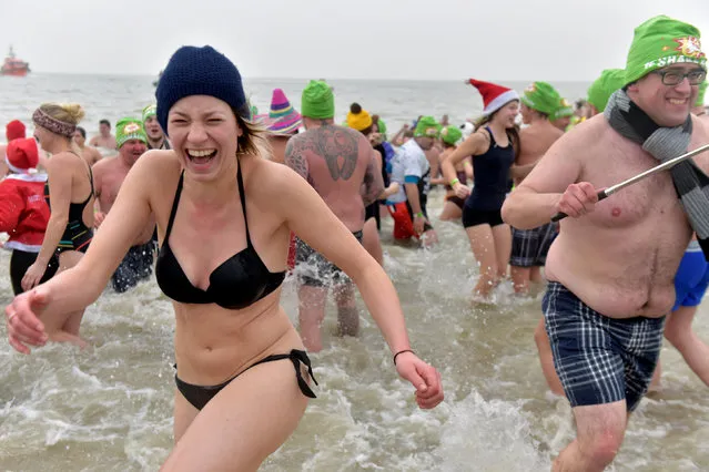 Revellers take part in a New Year's dive in Ostend on the North Sea coast in Belgium January 1, 2017. (Photo by Eric Vidal/Reuters)
