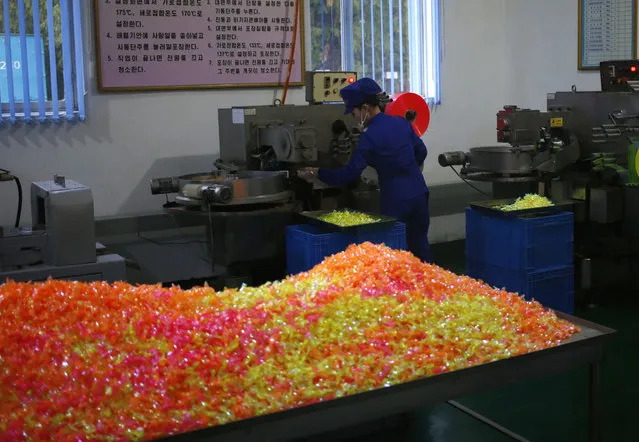 In this October 22, 2018 photo, a worker monitors the production of sweets at Songdowon General Foodstuffs Factory in Wonsan, North Korea. The factory produces cookies, crackers, candies and bakery goods, plus dozens of varieties of soft drinks, that are sold all across the country. North Korean leader Kim Jong Un is waging a campaign to rally the nation behind his economic goals with on-the-spot guidance and calls for managers to step up their game. Though the international spotlight is on his nuclear talks with Washington, Kim has a lot riding domestically on making good on promises to boost the country’s economy and standard of living. And when the leader comes a calling, he has little patience for cadres lacking in “revolutionary spirit”. (Photo by Dita Alangkara/AP Photo)