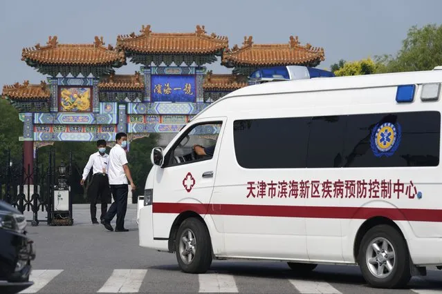 Security guards watch as a vehicle for the epidemic control center pulls up to the entrance into the Tianjin Binhai No. 1 Hotel where U.S. and Chinese officials are expected to hold talks in Tianjin municipality in China Monday, July 26, 2021. America's No. 2 diplomat has arrived in China to discuss the fraught relationship between the two countries on Monday with two top Foreign Ministry officials. (Photo by Ng Han Guan/AP Photo)
