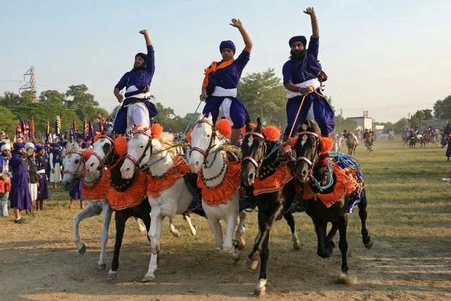 Nihang or Sikh warriors ride horses on the occasion of Fateh Divas in Amritsar on November 13, 2023. (Photo by Narinder Nanu/AFP Photo)