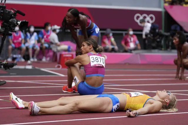 Viktoriya Tkachuk, of Ukraine, lies on the track after the final of the women's 400-meter hurdles at the 2020 Summer Olympics, Wednesday, August 4, 2021, in Tokyo. (Photo by Matthias Schrader/AP Photo)