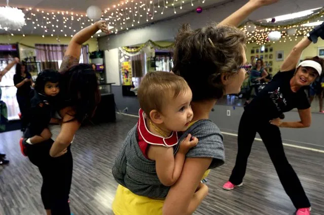 Tatyana Frost, right, leads a group of moms in an exercise class at Way 2 Dance Studio in Brandon, Fla., Tuesday, April 14, 2015. On the left is Julie Ann Padilla and 16 month old Josiah in the middle is Amber Riley with Amyia Kate Riley, 11 months. (Photo by Skip O'Rourke/The Tampa Bay Times via AP Photo)