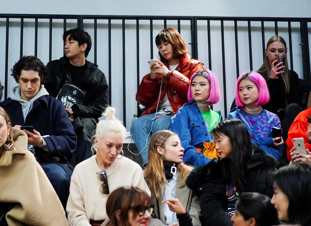 People wait for the JW Anderson catwalk show to begin at London Fashion Week Women's A/W19 in London, Britain February 18,  2019. (Photo by Henry Nicholls/Reuters)