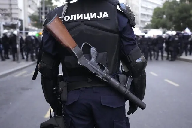 Serbian police guards the area as demonstrators take the streets to protest potential new COVID-19 restrictions announced by the government in Belgrade, Serbia, Saturday, September 18, 2021. (Photo by Darko Vojinovic/AP Photo)