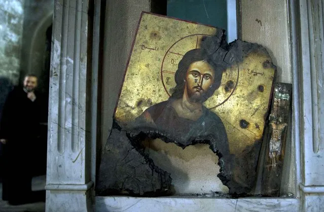 A half-burned image of Christ is placed next to a wall at a Greek Orthodox church in Maaloula, Syria, Thursday, March 3, 2016. Maaloula, an ancient Christian town 60 kilometers (40 miles) northeast of Damascus, changed hands several times in the war. Its historic churches pillaged by jihadis and buildings riddled with shrapnel reflect fierce fighting that devastated the town two years ago. (Photo by Pavel Golovkin/AP Photo)
