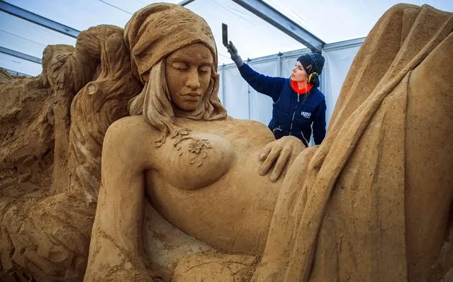 Marieke van der Meer from the Netherlands works on her sculpture “Flora” at the sand sculpture show in Binz on Ruegen island, Germany, 09 March 2016. With the motto “Fascination Nature”, 50 sand artists have created oversized sculptures. The sculptors use 16,000 tons of special sand that is pressed into big blocks first and then formed. The 7th sand sculpture show on 5,600 square meters of exhibition ground opens on 12 March 2016. (Photo by Ens Buettner/EPA)