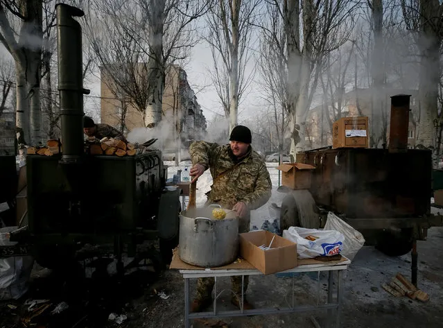 A serviceman prepares a meal at an emergency center after shelling hit supply infrastructure in the government-held industrial town of Avdiyivka, Ukraine, February 3, 2017. (Photo by Gleb Garanich/Reuters)