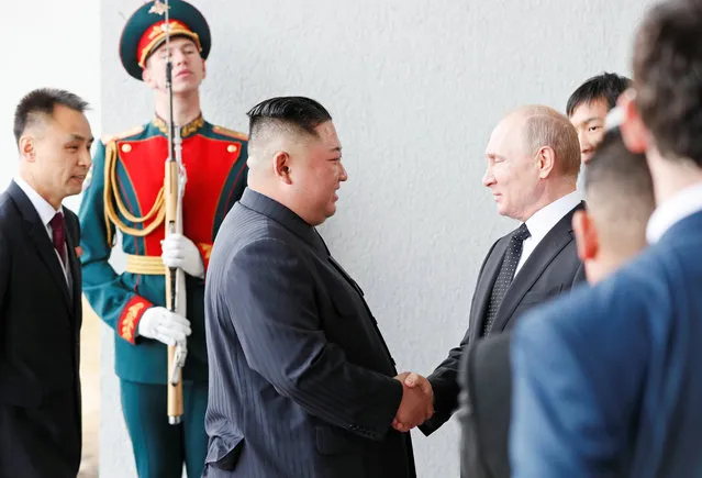 Russia's President Vladimir Putin shakes hands with North Korea leader Kim Jong Un at the Far Eastern Federal University campus at Russky Island in the far eastern city of Vladivostok, Russia on April 25, 2019. (Photo by Shamil Zhumatov/Reuters)
