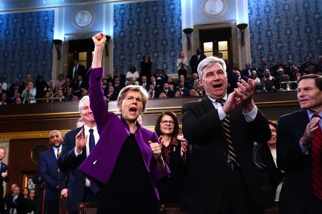 Democratic Senators Elizabeth Warren from Massachusetts (L) and Sheldon Whitehouse from Rhode Island (L) cheer as US President Joe Biden delivers his third State of the Union address in the House Chamber of the US Capitol in Washington, DC, on March 7, 2024. (Photo by Shawn Thew/Pool via AFP Photo)