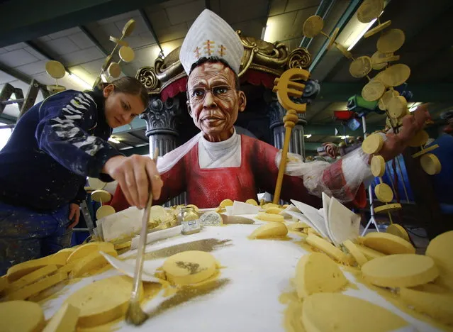 A carnival enthusiast works on a papier mache figure for a carnival float depicting Bishop Franz-Peter Tebartz-van Elst of Limburg, in preparations for the upcoming Rose Monday carnival parade in Mainz February 25, 2014. Tebartz-van Elst reaped stiff criticism from German Catholics and the title “luxury bishop” in the media after it was revealed he spent at least 30 million euros ($40.69 million) on a new residence complex. (Photo by Ralph Orlowskk/Reuters)
