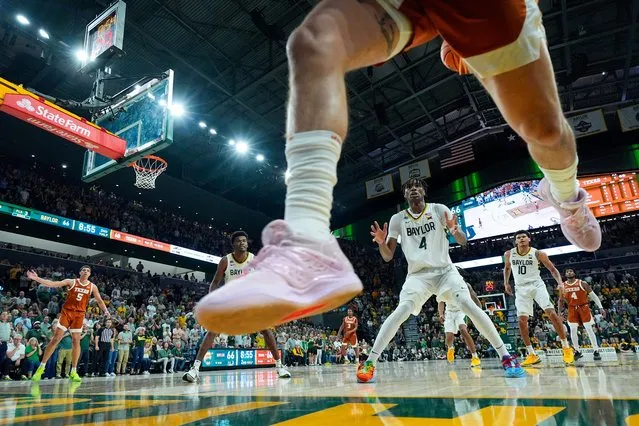 Texas's Brock Cunningham, top, tries to keep the ball in bounds against Baylor's Ja'Kobe Walter (4) and RayJ Dennis (10) during the second half of an NCAA college basketball game in Waco, Texas on March 4, 2024. Baylor won 93-85. (Photo by Julio Cortez/AP Photo)