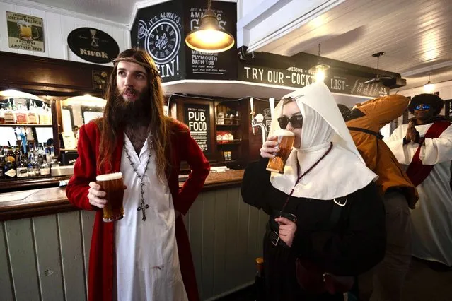 A group of pub crawl enthusiasts, dressed as Jesus and other biblical characters, partake in a Christathon, a pub crawl in Central London on Easter Sunday on March 31, 2024. (Photo by Hesther Ng/Story Picture Agency)