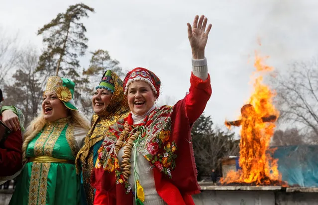 Revellers cheer in front of a burning effigy of Lady Maslenitsa during celebration of Maslenitsa, or Pancake Week, in Almaty, Kazakhstan, February 25, 2017. (Photo by Shamil Zhumatov/Reuters)