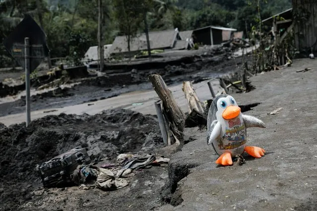A penguin balloon is seen at an area affected by the eruption of Mount Semeru volcano, in Kamar Kajang, Candipuro district, Lumajang, East Java province, Indonesia, December 9, 2021. (Photo by Willy Kurniawan/Reuters)