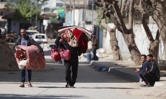 Palestinians leave their homes with their belongings in the Nuseirat refugee camp in central Gaza on April 12, 2024, amid the ongoing conflict between Israel and the Palestinian militant group Hamas. (Photo by AFP Photo/Stringer)