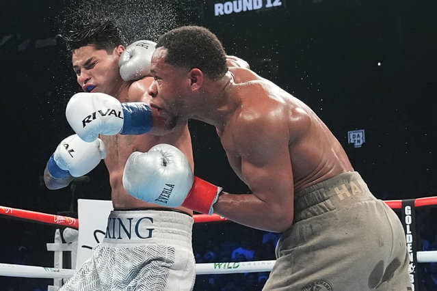 Devin Haney, right, punches Ryan Garcia during the 12th round of a super lightweight boxing match early Sunday, April 21, 2024, in New York. (Photo by Frank Franklin II/AP Photo)