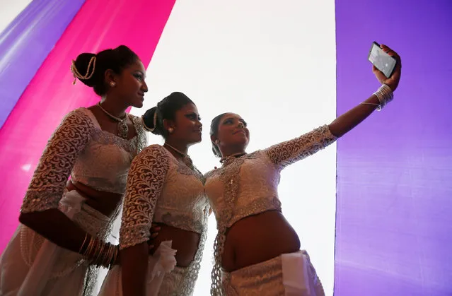 A group of female traditional dancers take selfies at the backstage during International Women's Day celebrations in Colombo, Sri Lanka, March 8, 2017. (Photo by Dinuka Liyanawatte/Reuters)