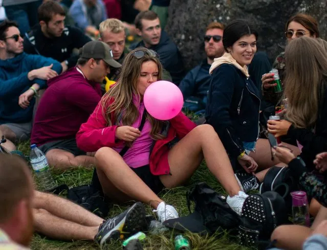 A festival goer breathe nitrous oxide on the first day of the Glastonbury Festival at Worthy Farm in Somerset, Britain 26 June 2019. Glastonbury Festival of Contemporary Performing Arts is a five-day festival of contemporary performing arts that takes place in Pilton, Somerset, west England, from 26 to 30 June 2019. (Photo by South West News Service)