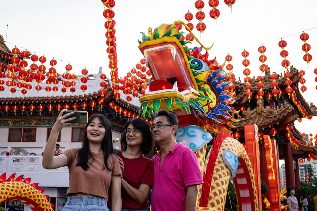 People take picture with a decorative dragon lantern during a Lunar New Year celebration at Thean Hou Temple on February 09, 2024, in Kuala Lumpur, Malaysia. Chinese New Year in Malaysia is marked by family gatherings, festive adornments and traditional rituals embodying a spirit of hope and renewal for the year ahead, and aims to bring joy and prosperity to all while fostering a sense of unity and hope for a successful Year of the Dragon. (Photo by Annice Lyn/Getty Images)