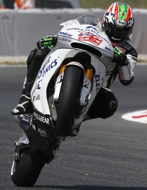 US MotoGP rider Nicky Hayden of the Aspar MotoGP team performs a wheelie during third free practice session for the motorcycle GP in Montmelo, Spain, Saturday, June 13, 2015. The Catalunya Grand Prix will take place on Sunday in Montmelo. (AP Photo/Manu Fernandez)