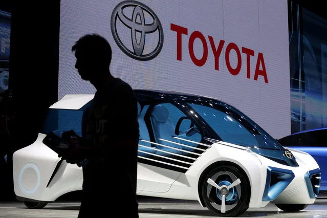 A man walks past the Toyota FCV Plus Concept car on display at the Beijing International Automotive Exhibition in Beijing, Monday, April 25, 2016. (Photo by Andy Wong/AP Photo)