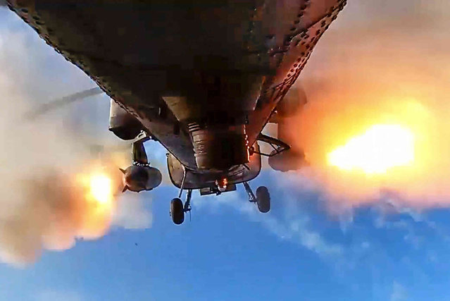 In this photo taken from video released by the Russian Defense Ministry Press Service on Saturday, February 3, 2024, a Mi-28N “Night Hunter” helicopter gunship of the Russian air force fires rockets at a target at an unknown location in Ukraine. (Photo by Russian Defense Ministry Press Service via AP Photo)